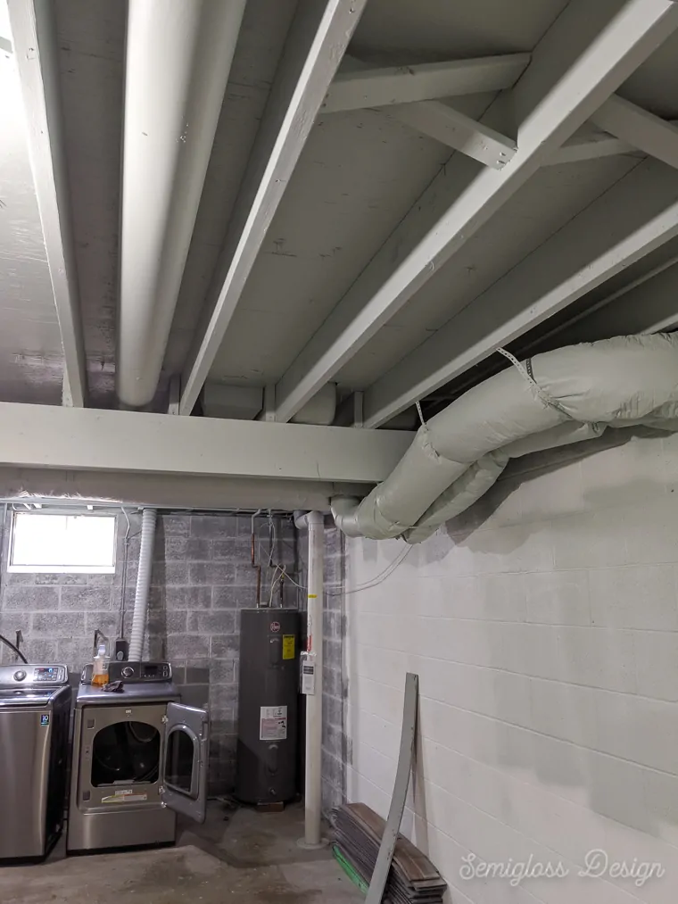 painted pipes and ducts in basement ceiling