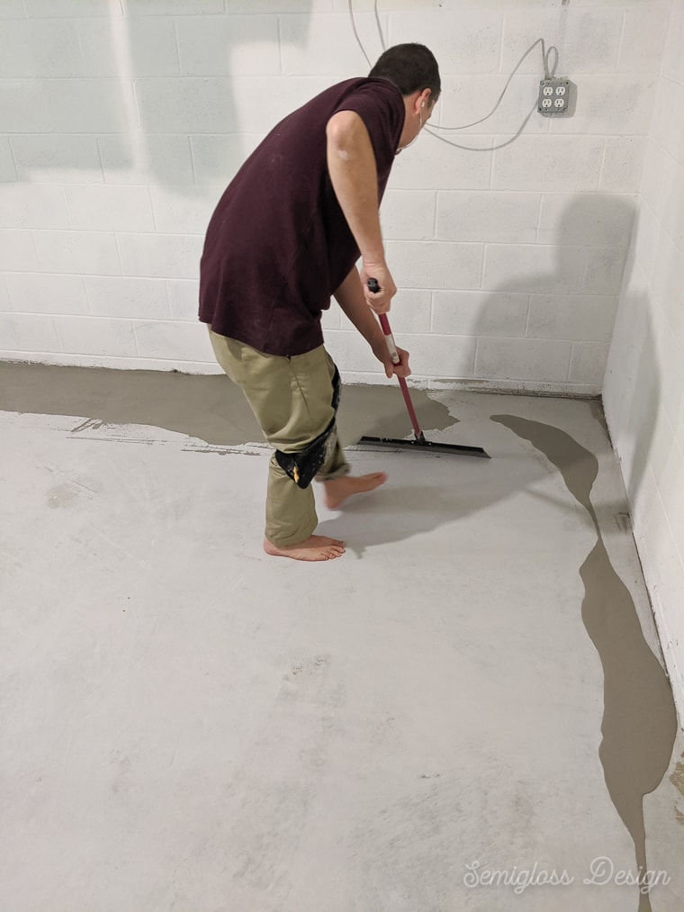 spreading 2nd coat of concrete on basement floor