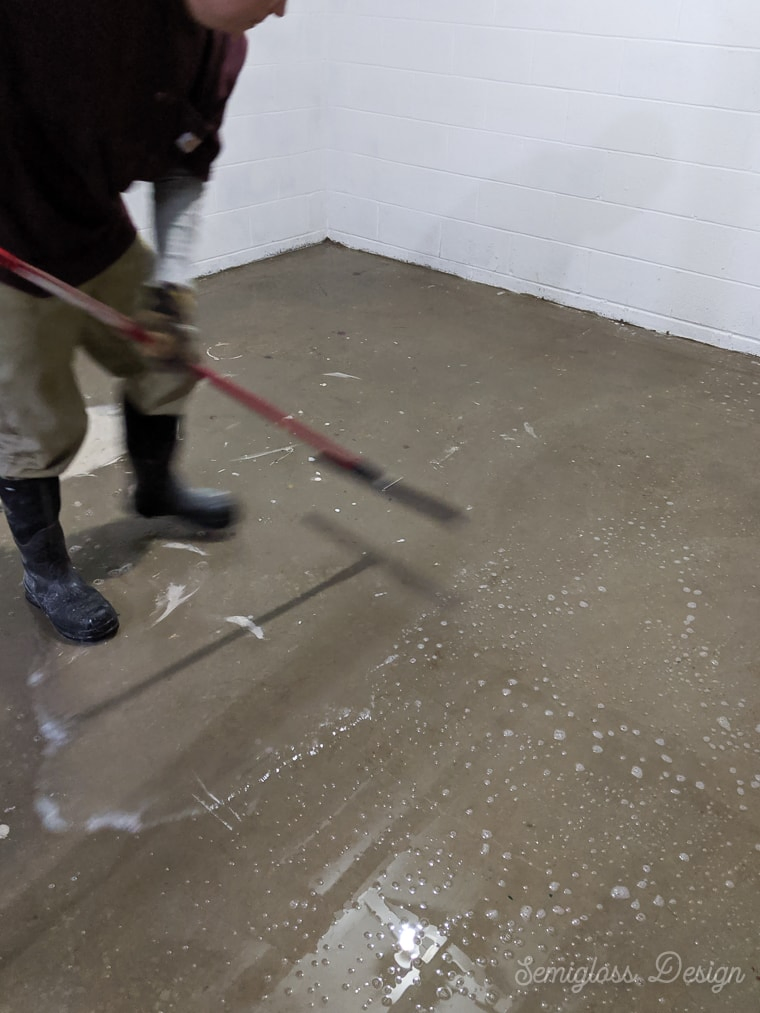 using a squeegee to push water to basement drain