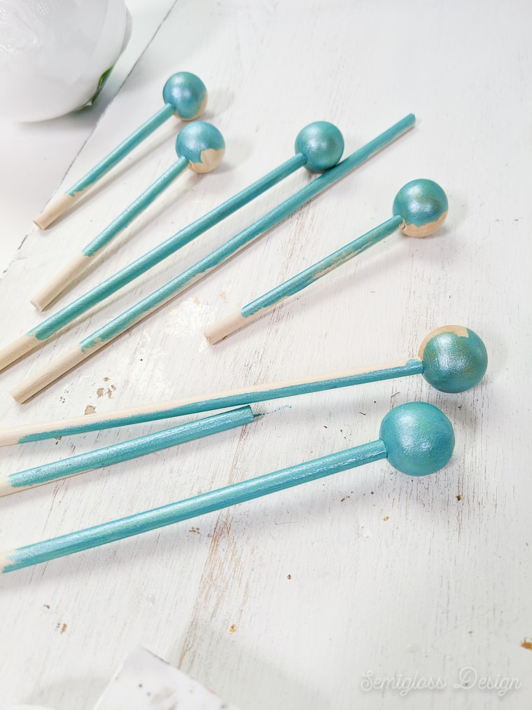 painting dowels with beads for tree topper