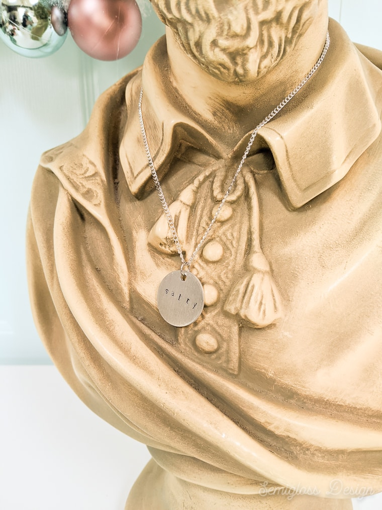 close up of "salty necklace on plaster bust of Shakespeare