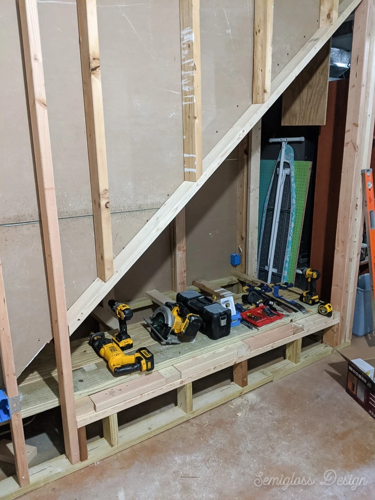 partially framed area under stairs in basement