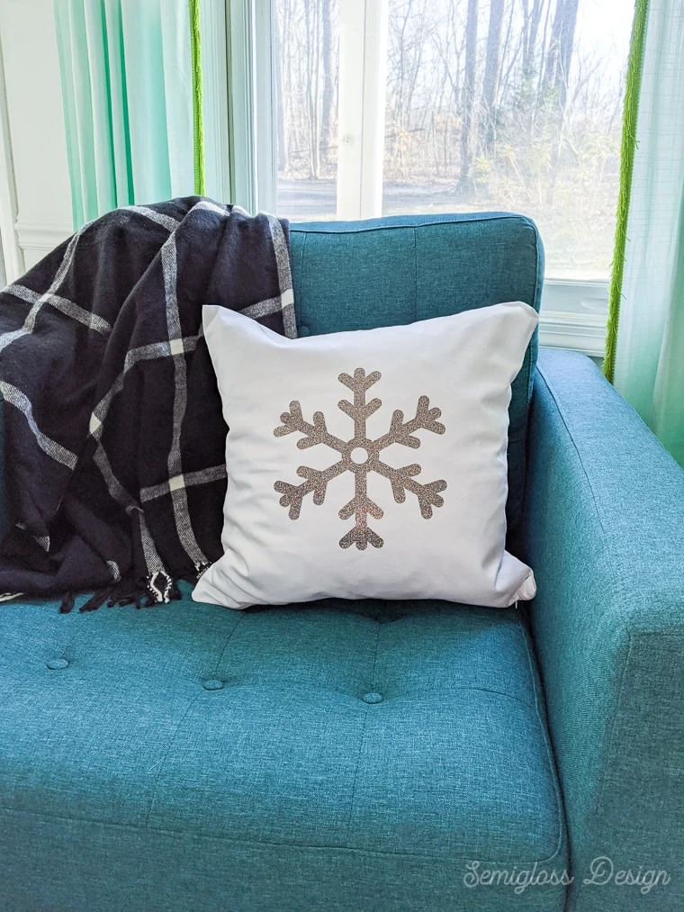 glitter snowflake pillow on turquoise chair