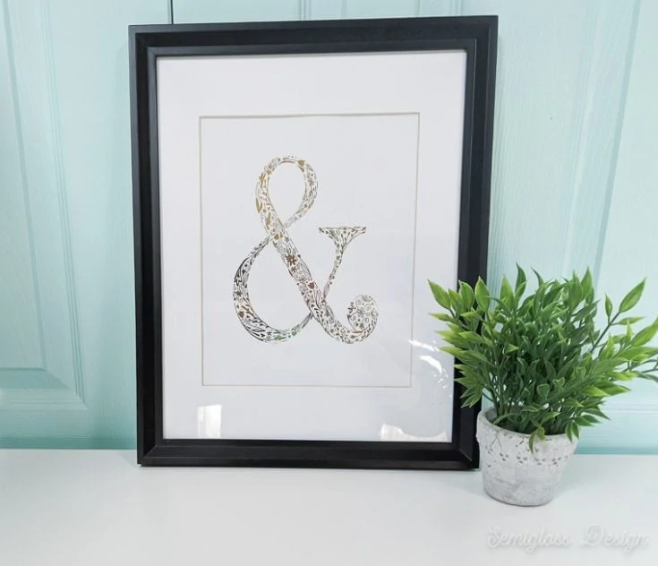 gold foil ampersand art in frame