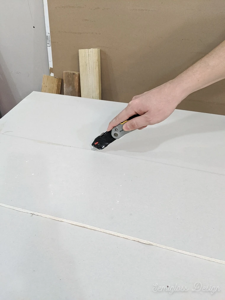 using utility knife to score drywall