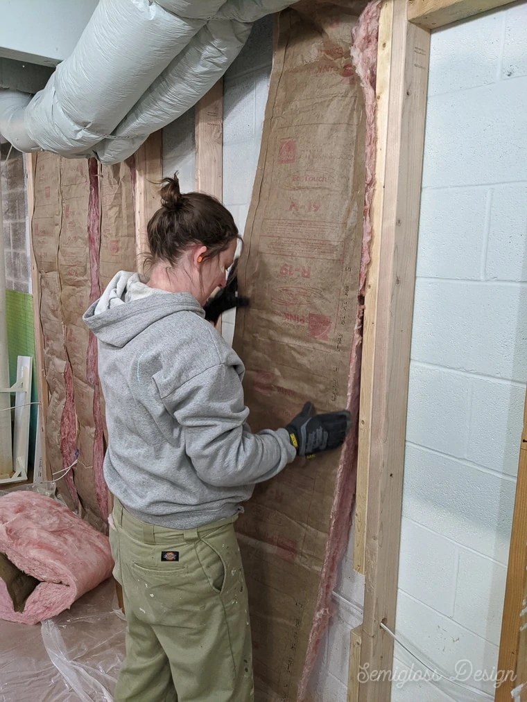 installing insulation between studs