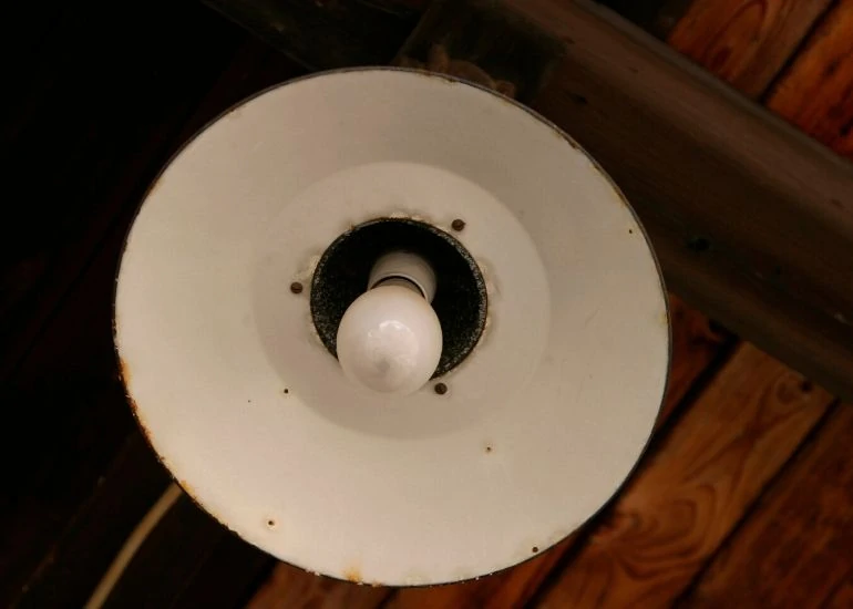 light fixture on wood ceiling