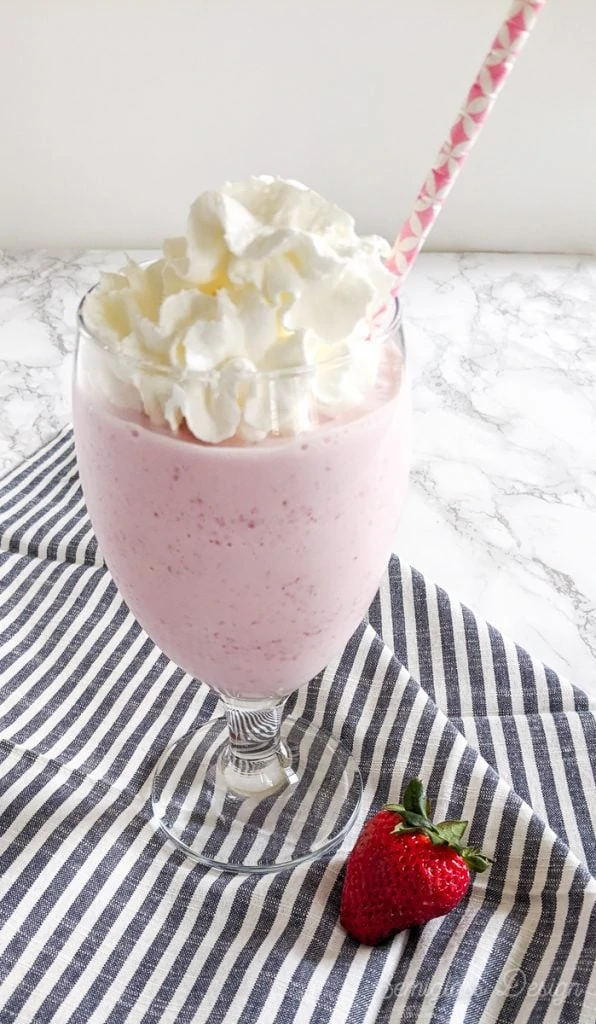 strawberry milkshake on black and white napkin