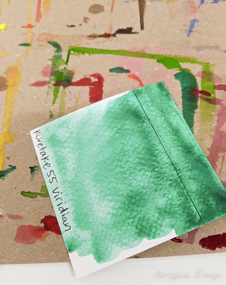 adding more water to the watercolor swatch to dilute the color