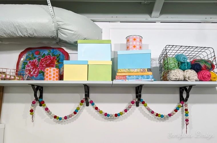 wall shelf with colorful boxes and books