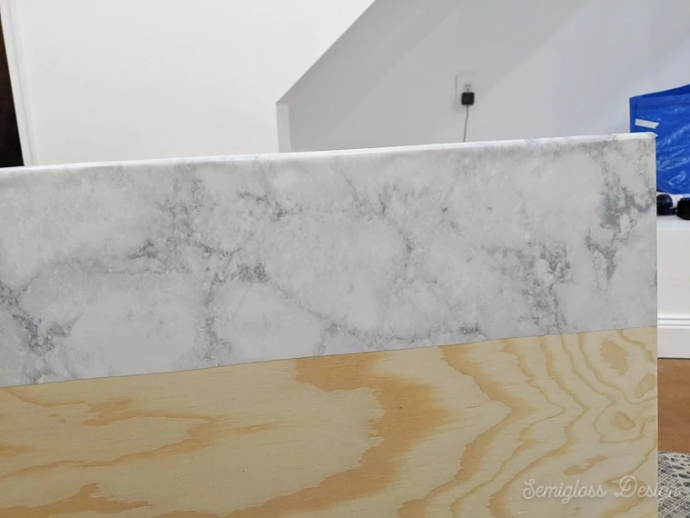 applying marble contact paper to wood top