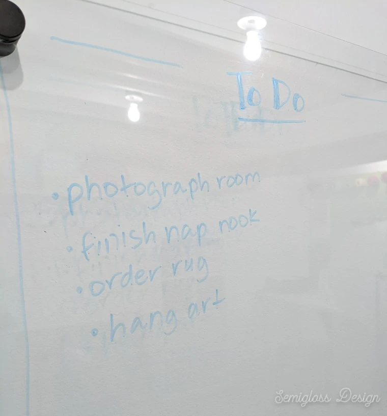 clear dry erase board with barely legible writing