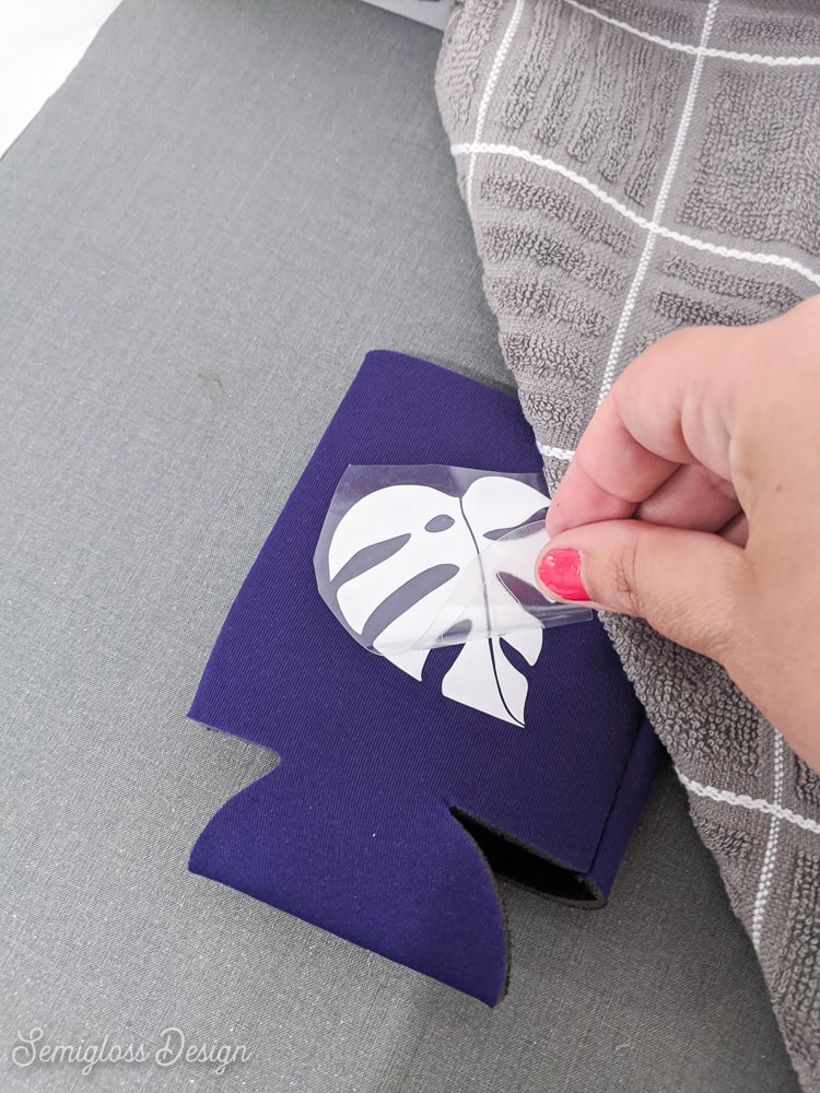 peeling away plastic backing from koozie