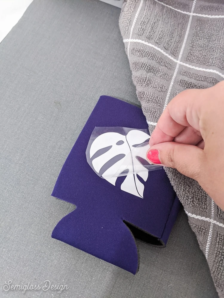 peeling away plastic backing from koozie
