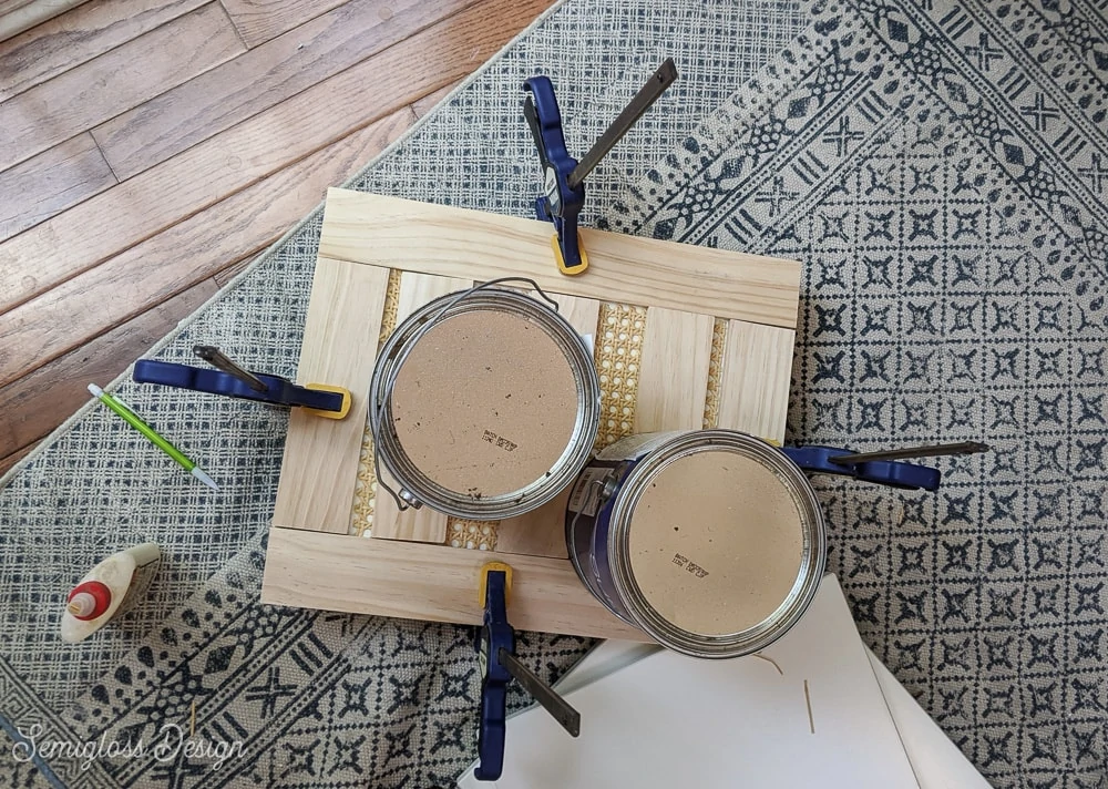 heavy paint cans sitting on cane while it dries