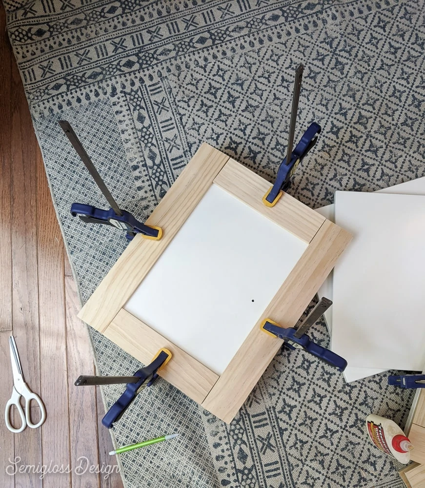 wood pieces clamped to panel