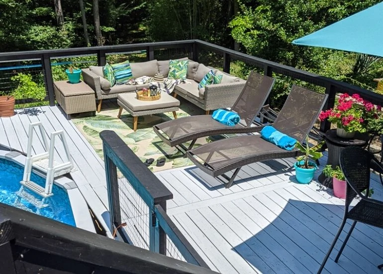 gray deck with modern furniture by pool