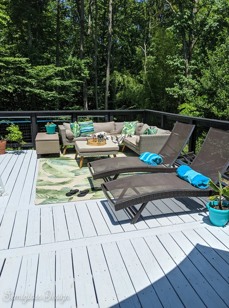 deck painted gray with modern black railing and furniture