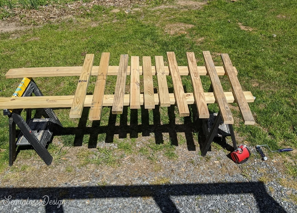 deck railing tops and bottoms laid out to be painted