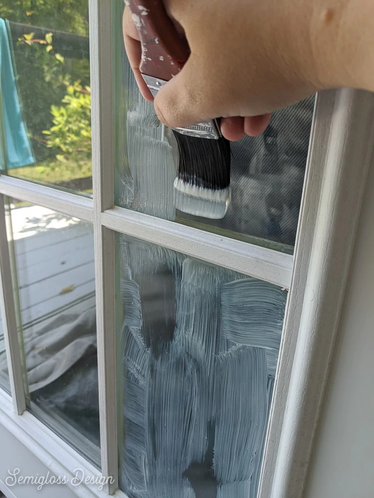 painting masking liquid onto glass panels