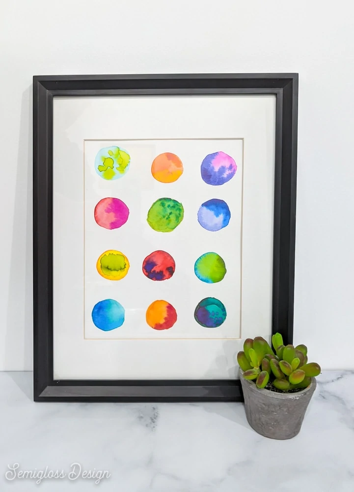 abstract watercolor art in frame with plant