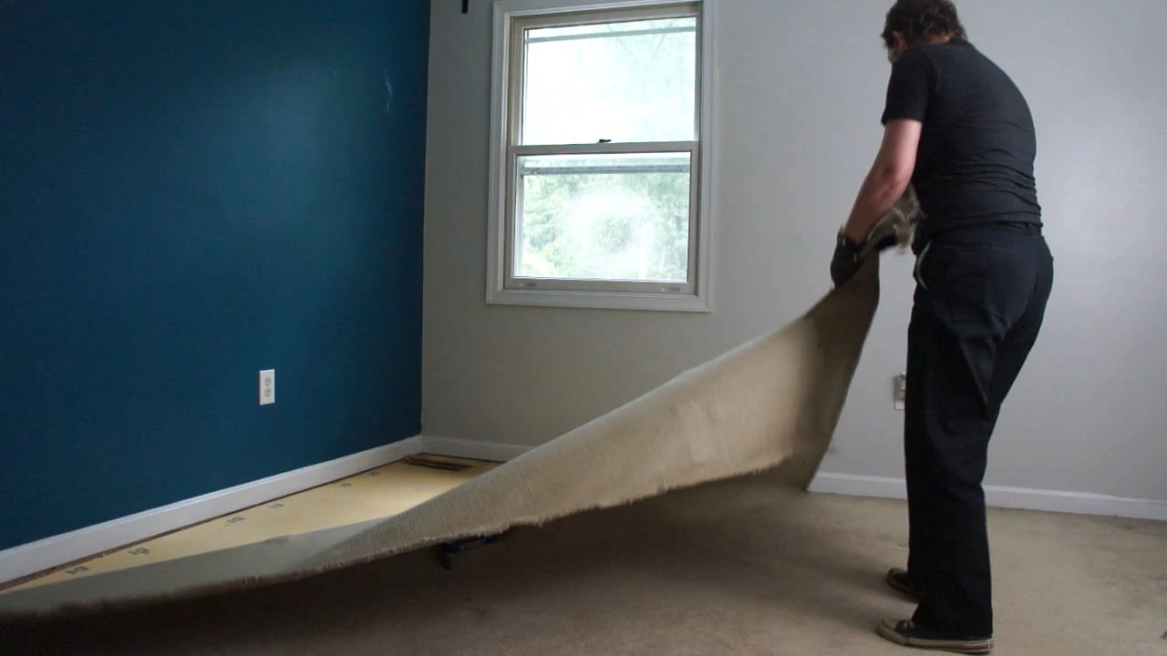 lady removing carpet