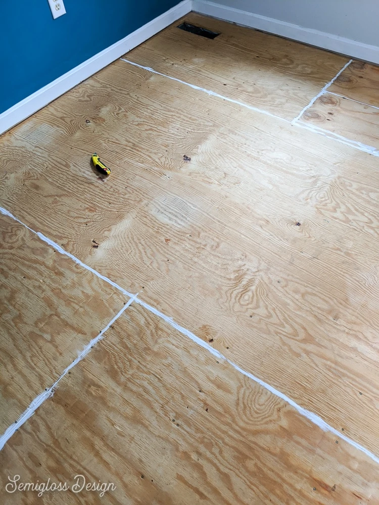 caulked seams of plywood floor