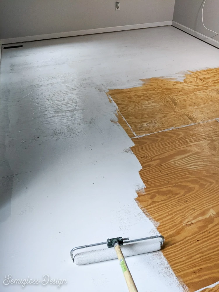 using large roller to paint floor