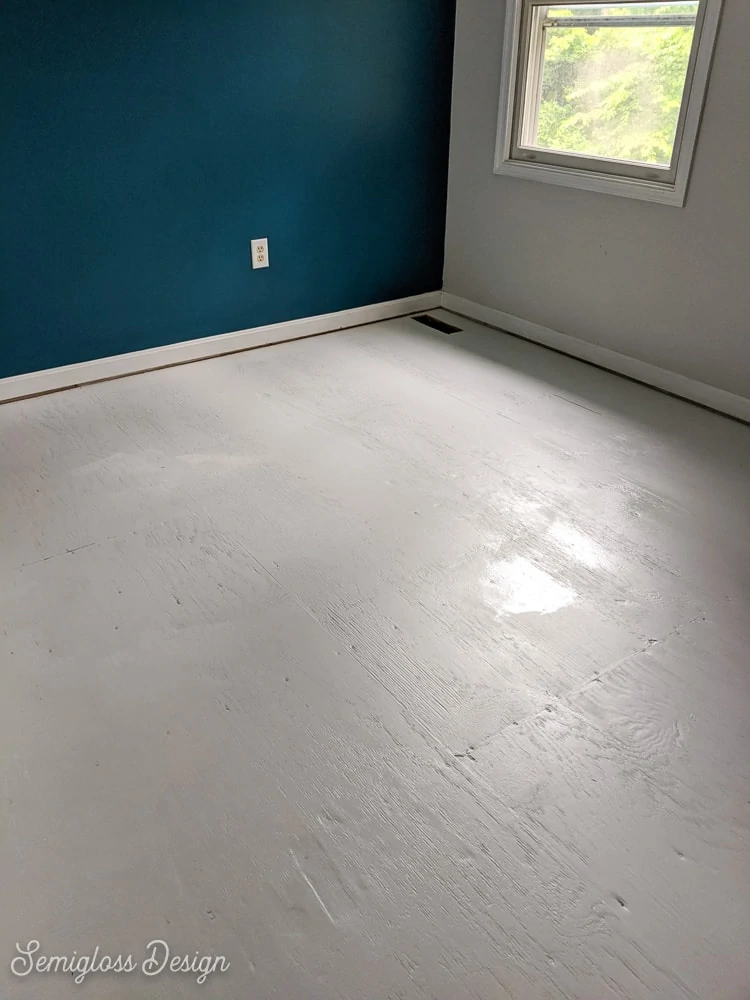 painting second coat of gray paint on floor