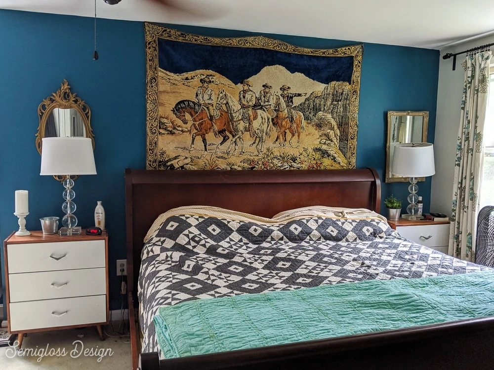 master bedroom before makeover blue walls with wood bed and black and white quilt)