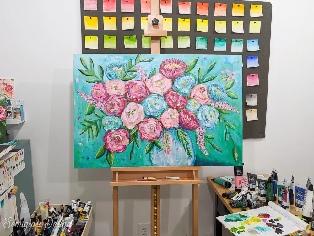 floral painting with pink and blue flowers on an aqua background