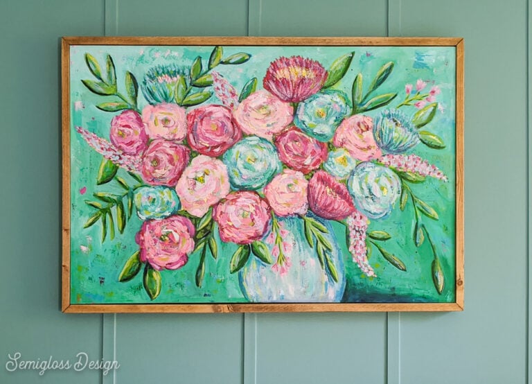 wood frame around floral painting with teal walls
