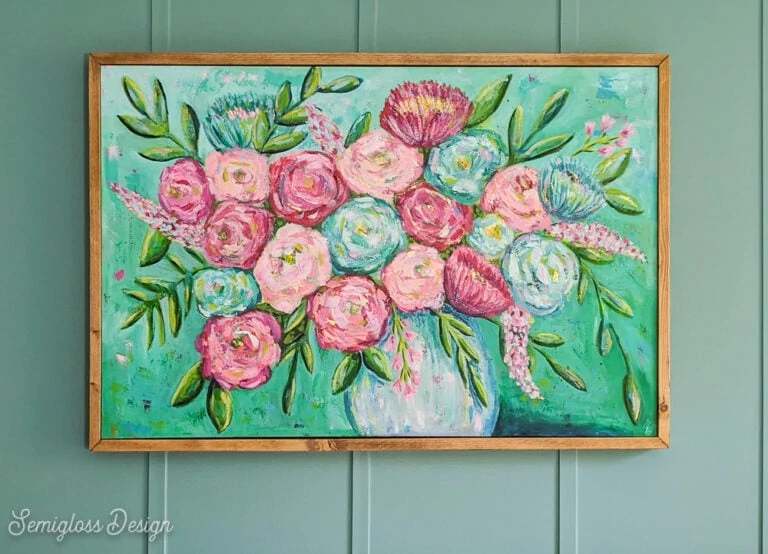 wood frame around floral painting with teal walls