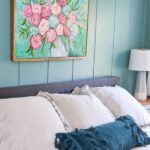 master bedroom with gray bedding and teal walls