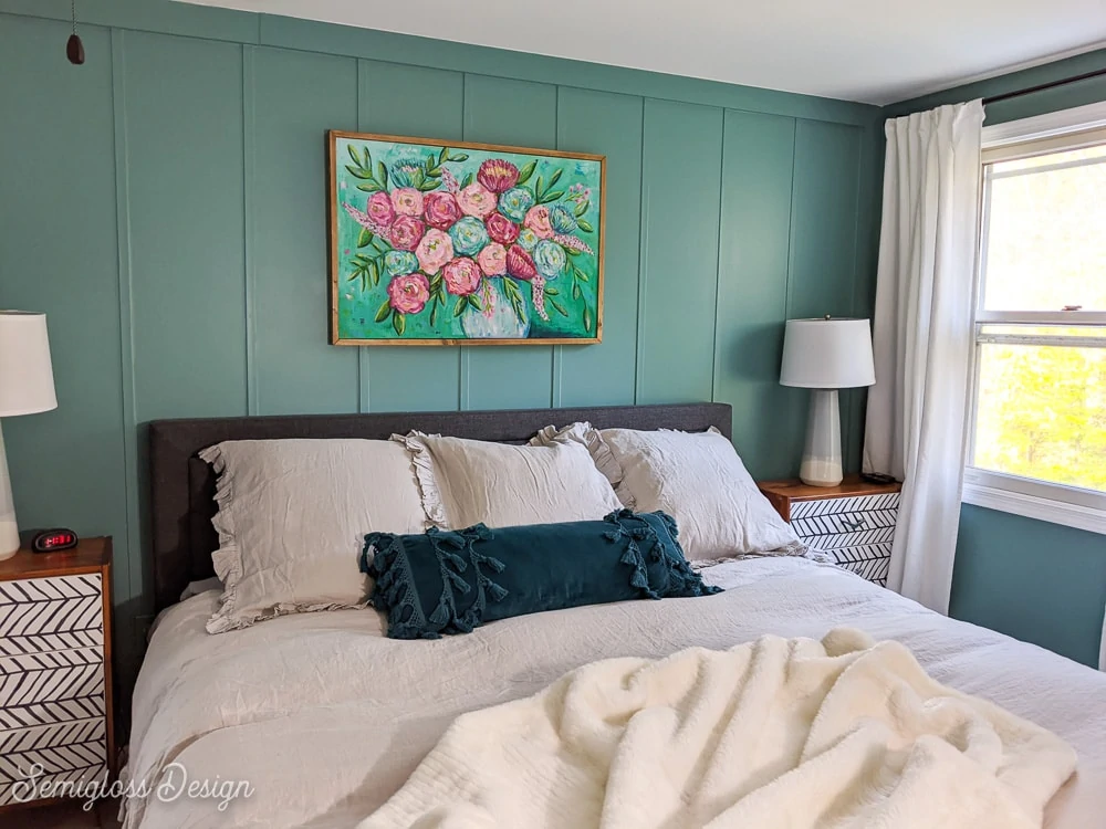 gray bed against teal walls
