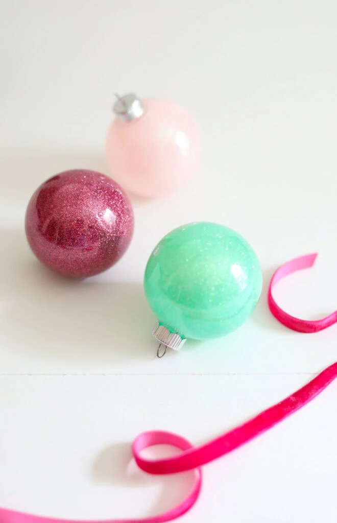 glitter ornaments in green, red, and pink
