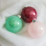 glitter ornaments on a white background