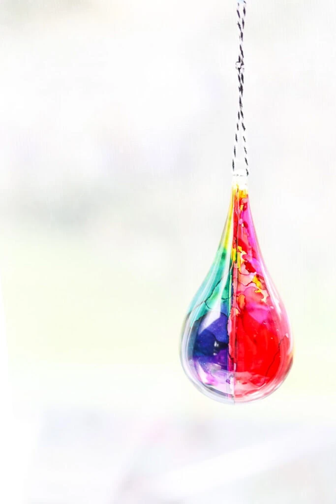 tear drop shaped ornament with rainbow colored alcohol ink effect
