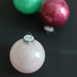 glitter ornaments on a black background