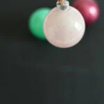 hand holding pink glitter ornament