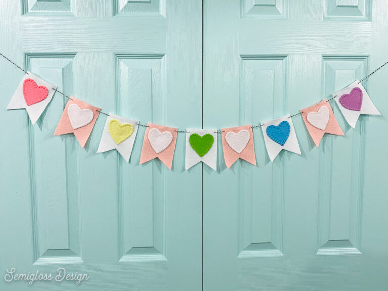 colorful felt heart banner on aqua doors