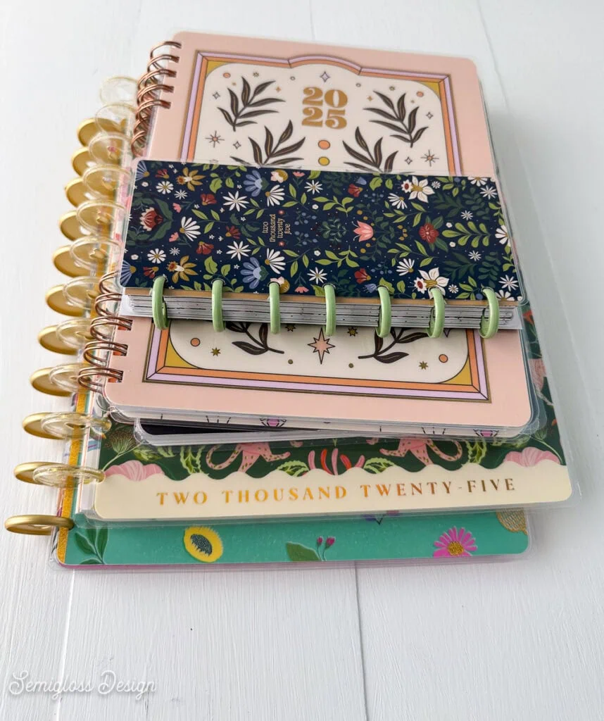 stack of happy planners with floral patterned covers