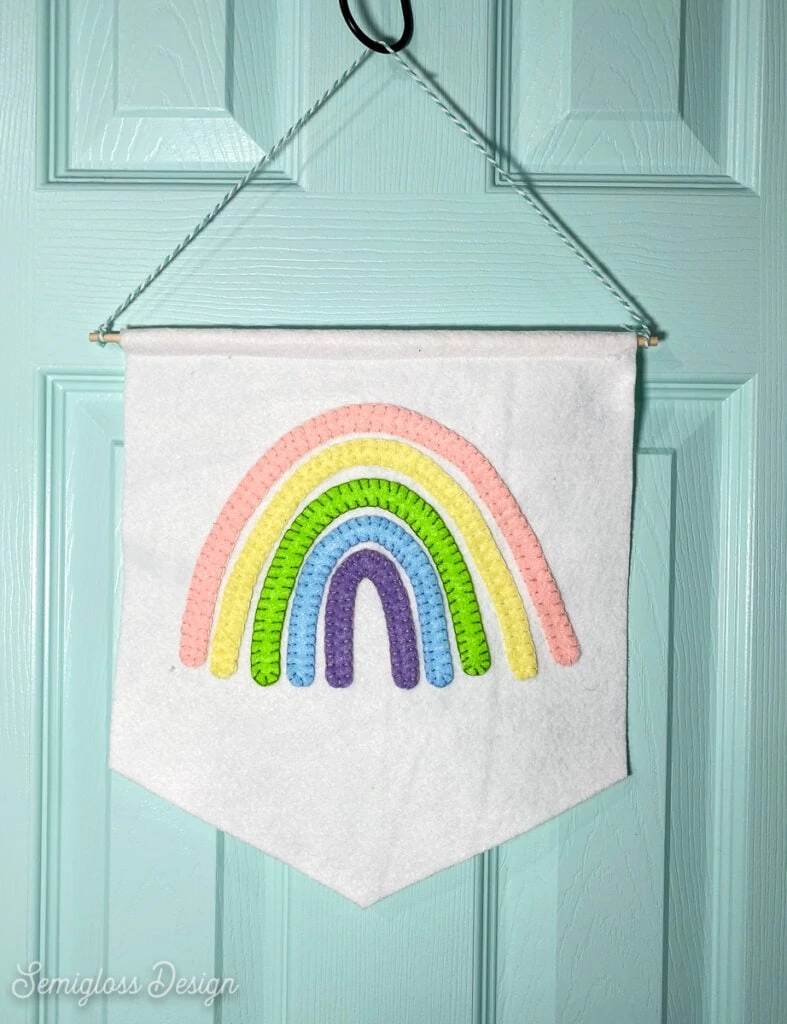 rainbow wall hanging on blue door