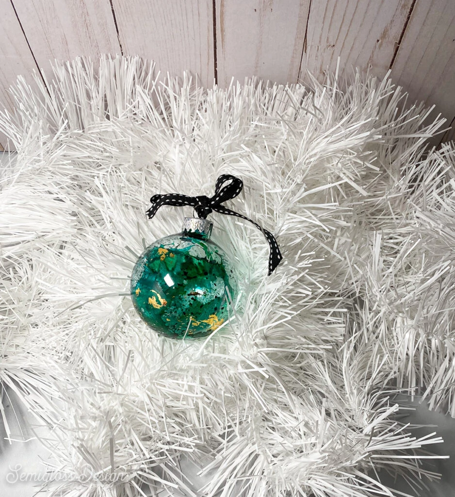 green ornament with gold leaf