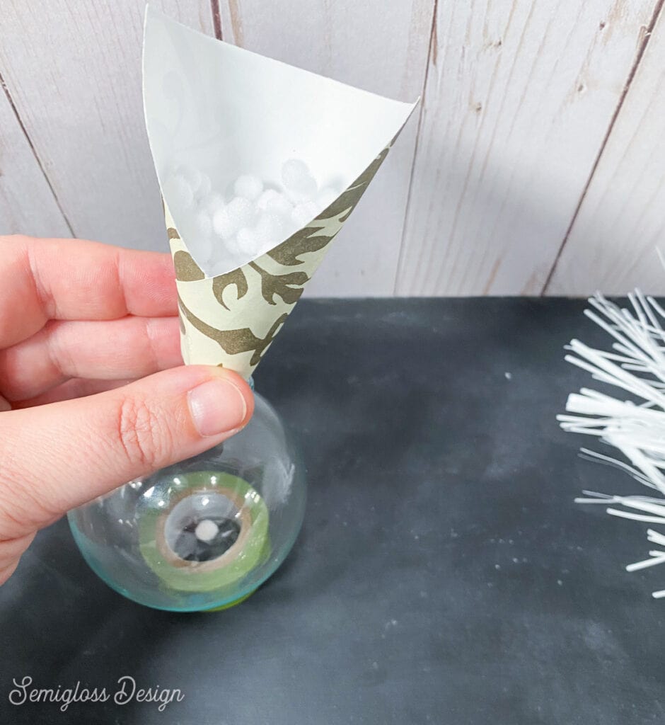 using paper as a funnel for glass ornament