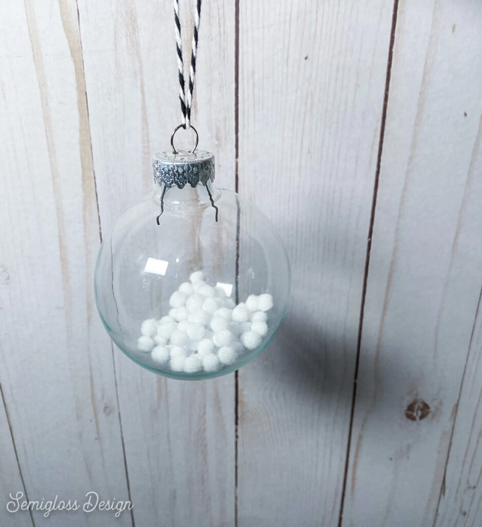 ornament filled with white fake snowballs