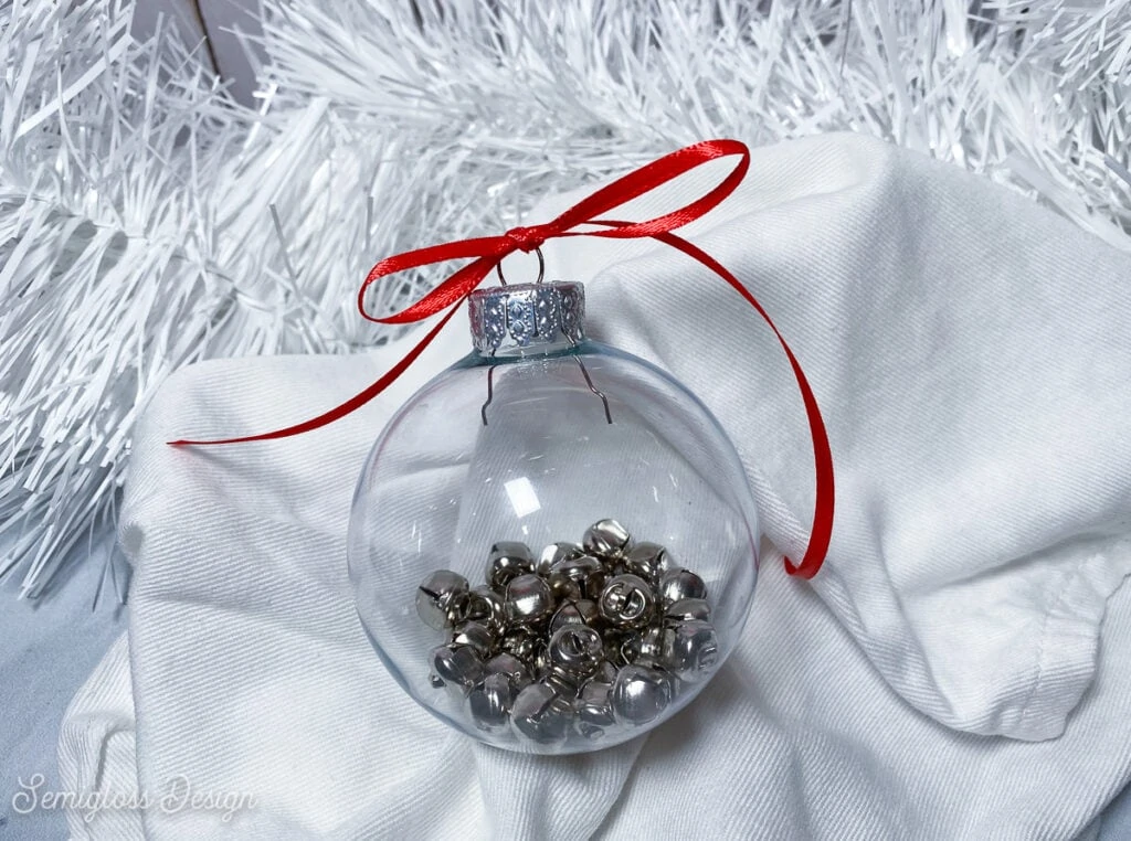 clear ornament filled with jingle bells