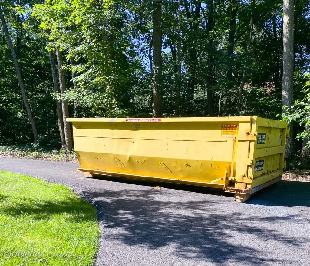 yellow dumpster in driveway