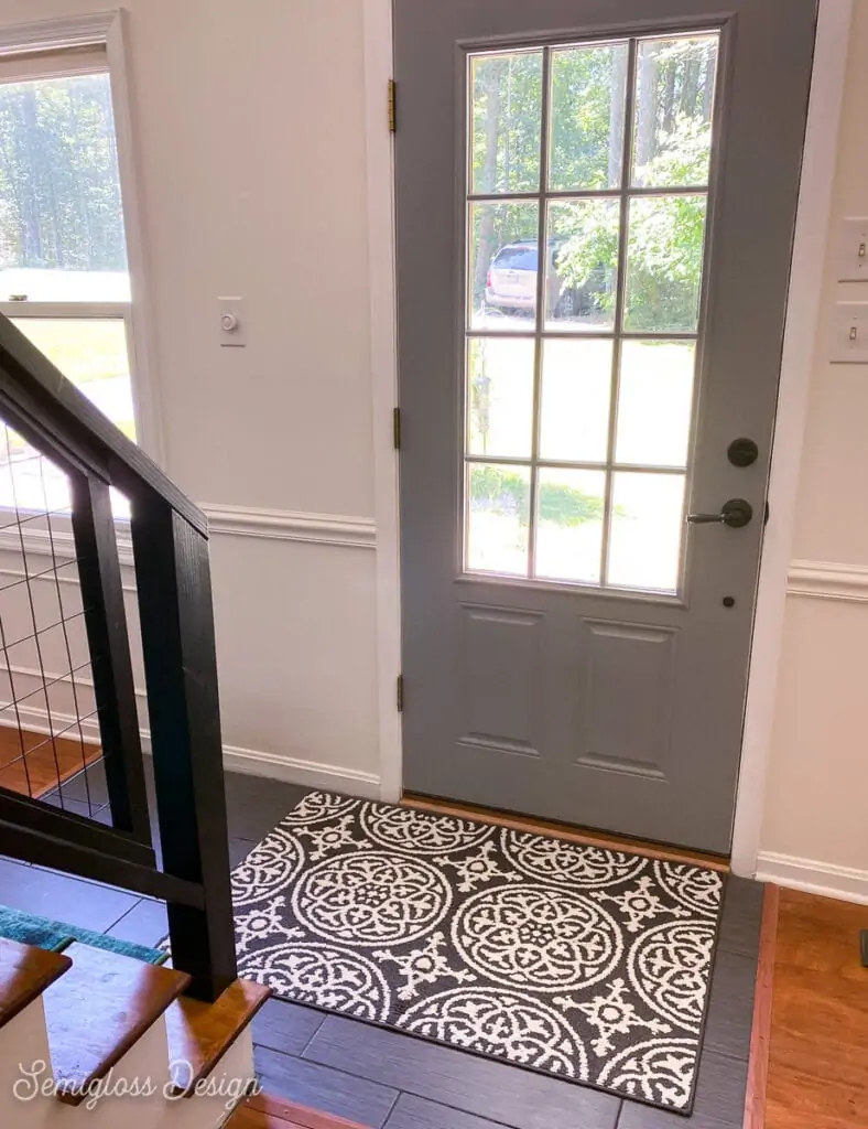 black and white rug in front entryway