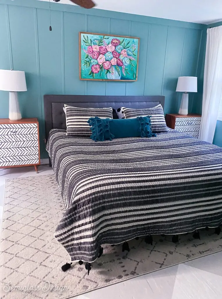 master bedroom with teal walls and black and white bedding